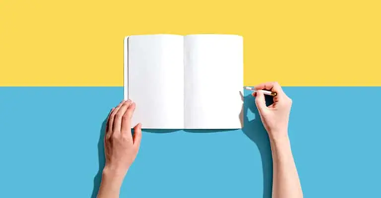 Two hands hold an open blank notebook against a bold yellow and blue background, with the right hand poised to write using a pencil. The image evokes creativity, planning, or the start of a new idea.