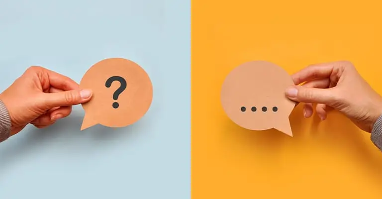 Split image showing two hands each holding a brown paper speech bubble against contrasting backgrounds. The left side, with a blue background, features a speech bubble with a question mark, while the right side, on a yellow background, shows a speech bubble with ellipsis dots, symbolizing a question-and-answer or ongoing conversation.