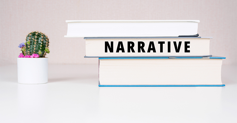 Stack of three hardcover books on a white table with the word “NARRATIVE” printed on the spine, next to a small potted cactus.