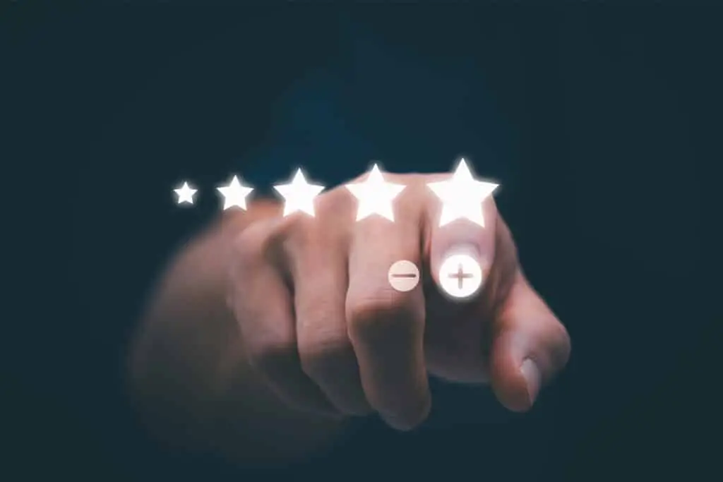 A hand points toward a row of five star icons with plus and minus buttons, suggesting an online rating being adjusted. The image represents managing reviews and customer feedback to support a positive professional online reputation.
