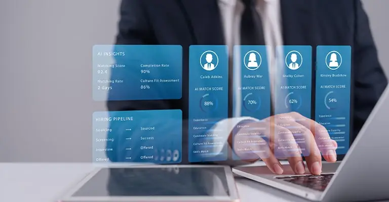 A business person types on a laptop while a digital hiring dashboard compares multiple candidate profiles and match scores. The scene connects to entry-level job search tips by showing how employers may use technology to screen applicants.